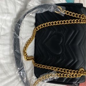 Luxurious Black quilted purse with gold chain.